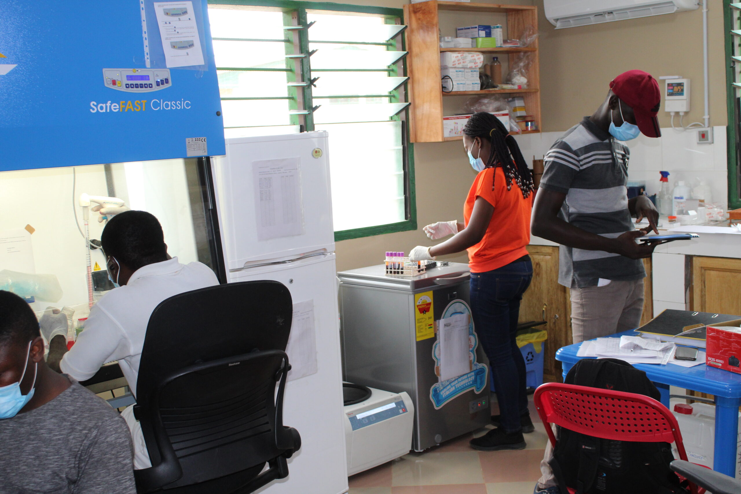 Research team members processing the participants’ samples in the field research laboratory